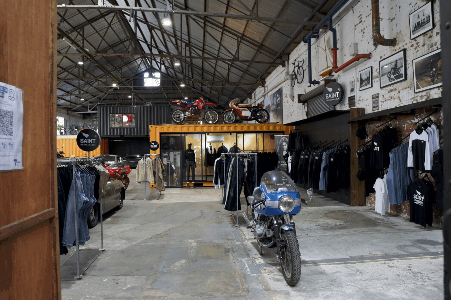 Warehouse pop up with clothing racks and motorcycles on display