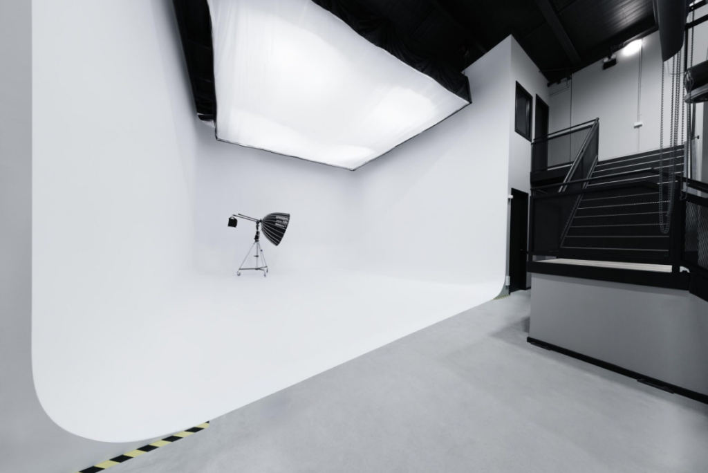 Creative studio in Melbourne with open floor layout, black ceiling, lounge seating, and industrial interior design