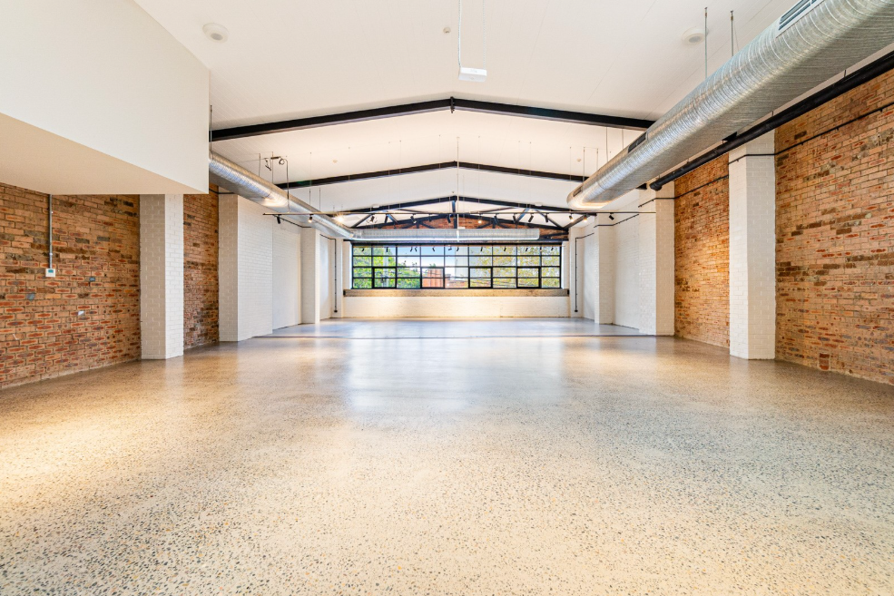 Empty retail space with display fixtures and lighting prepared for temporary use