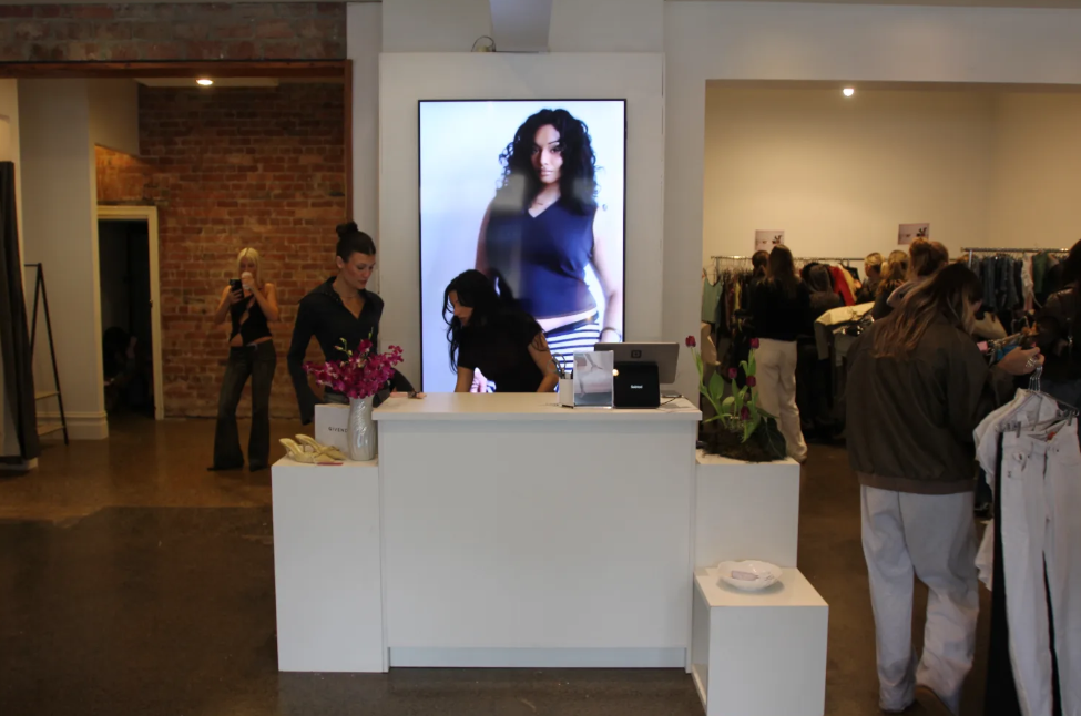 Pop-up retail space with customer area, counter and overhead lighting