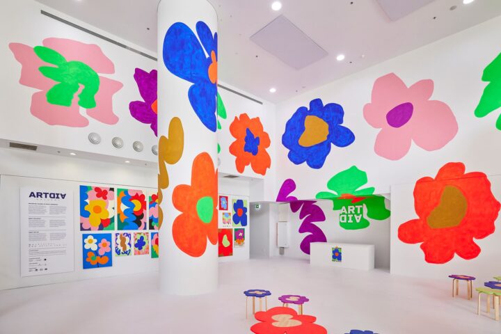 Colourful art activation with large painted flowers on white walls