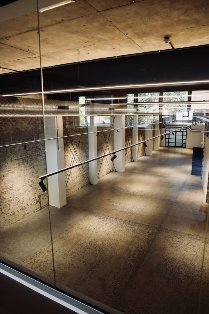 Empty lower-level space with brick walls and a concrete floor