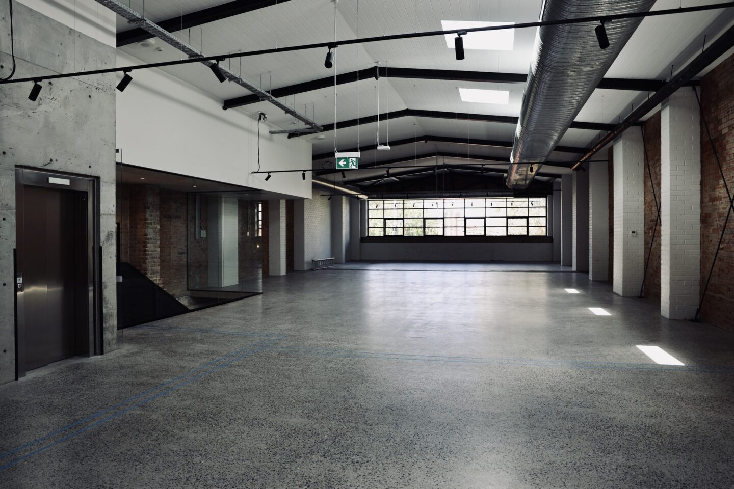 Empty warehouse space with concrete floors and high ceilings