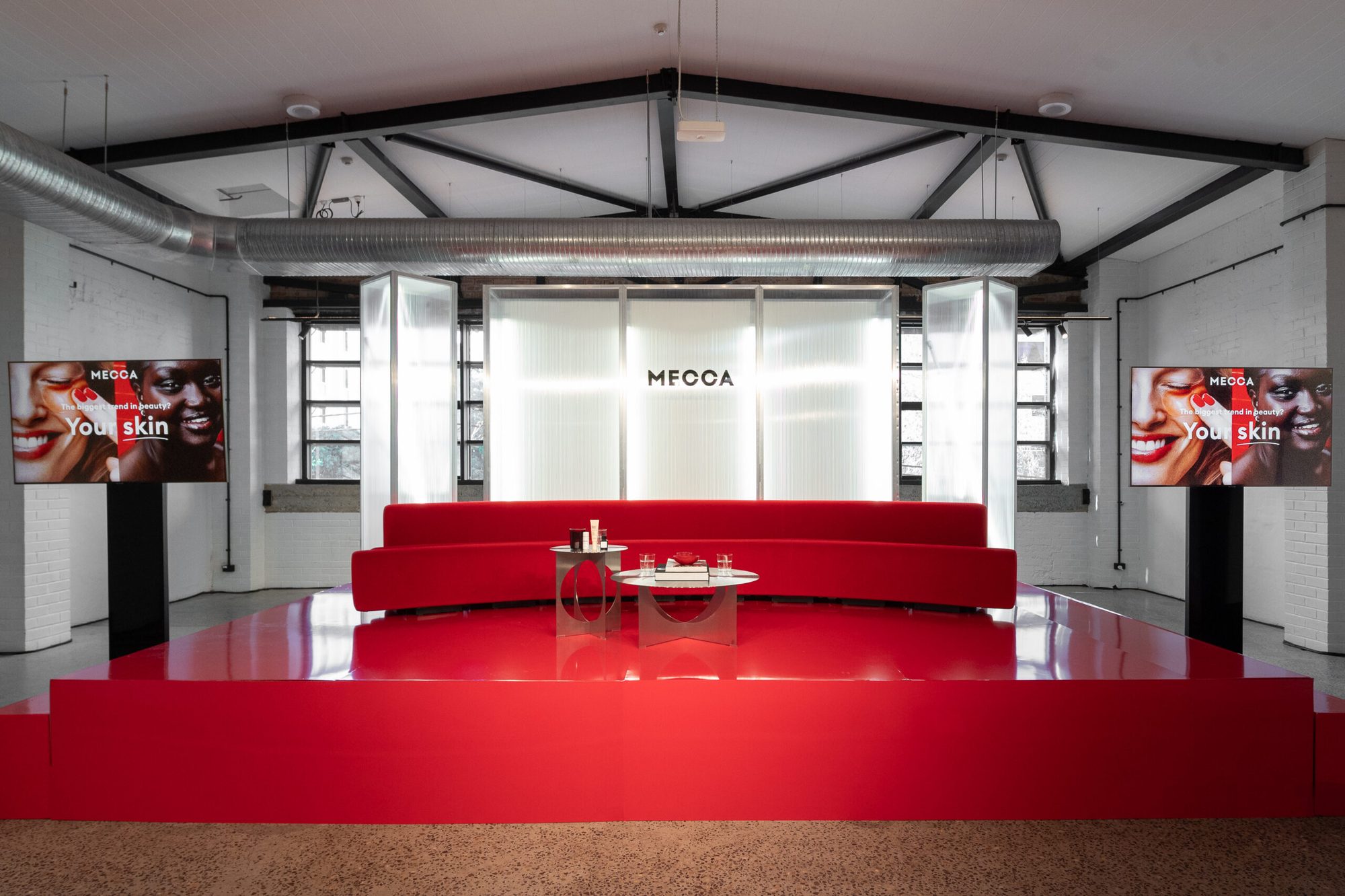 MECCA event lounge with seating and product tables
