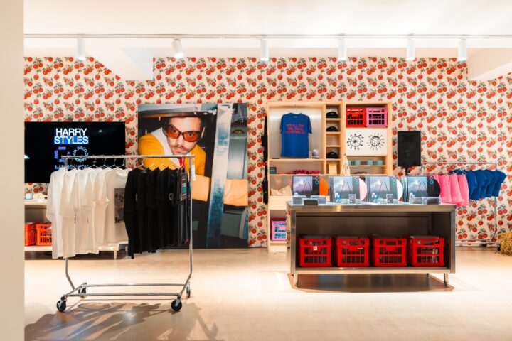 Harry Styles merchandise and vinyl displayed against tomato-patterned walls at Verona 1