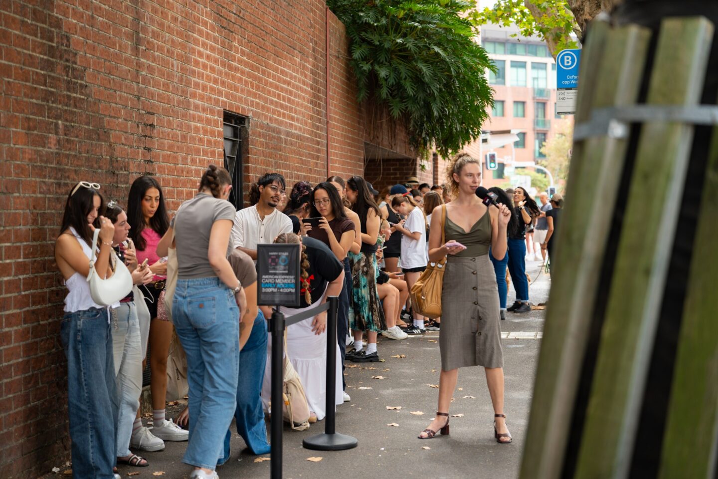 Fans queue along Oxford Street outside the Harry Styles pop up in Paddington
