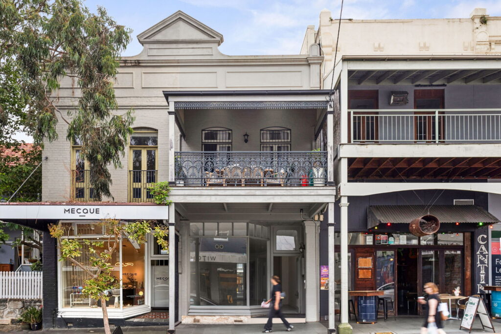 Street façade of 348 Darling Street in Balmain, with the retail shopfront beneath a decorative balcony