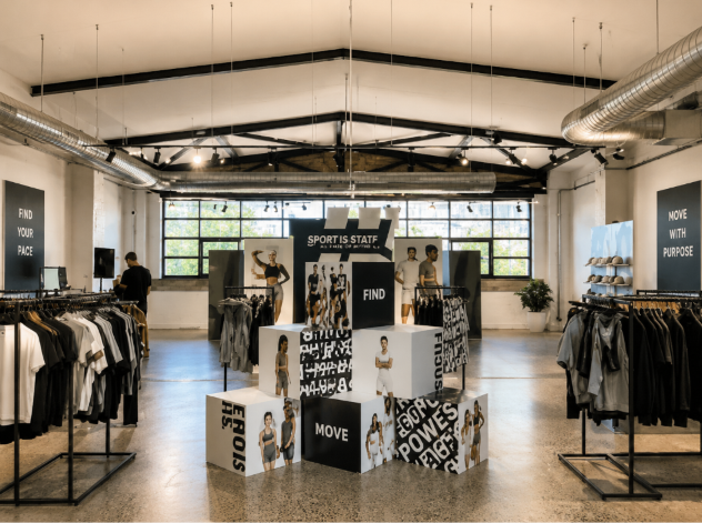 Modern retail shop with product displays, clothing racks and walk-in customer space